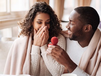 Man and woman with a ring in a box, both smiling