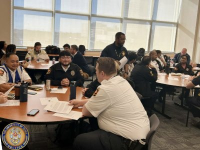 People in uniform sitting at table in discussion