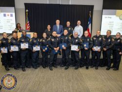 Group of UT Police employees posed for photo holding certificates