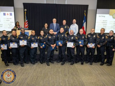 Group of UT Police employees posed for photo holding certificates