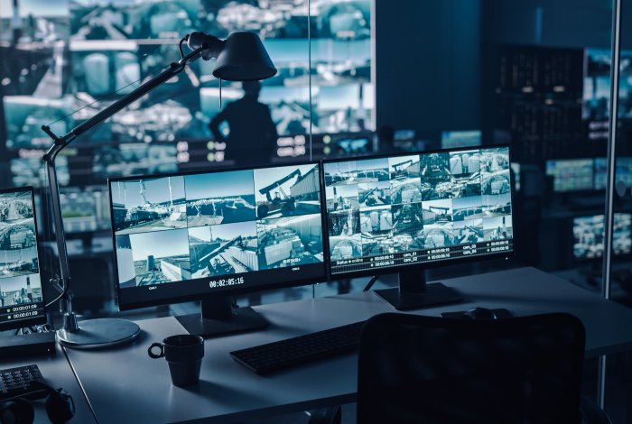 Police dispatch center depicting video cameras on screen