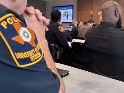 Arm of police officer sitting at conference table in a meeting