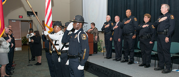 The Honor Guard presents the US and Texas flags.