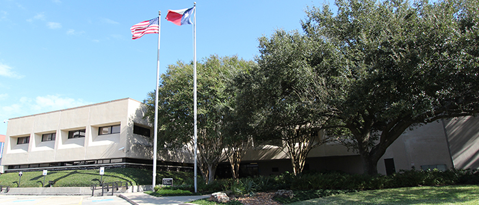 U.S. and Texas flags fly at UT Police at Houston headquarters, 7777 Knight Road.