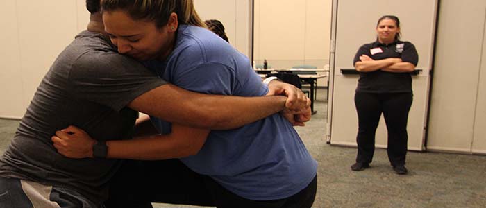 Women learn basic self defense techniques.