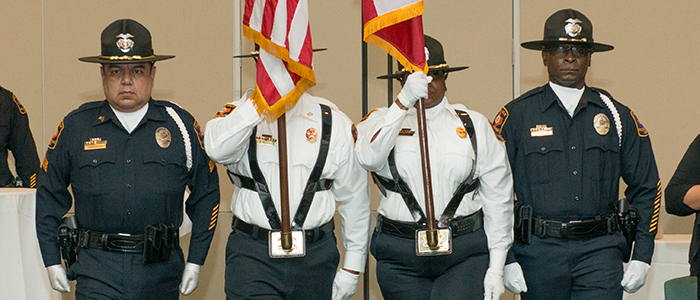 The UT Police Honor Guard presents the colors at a ceremony.