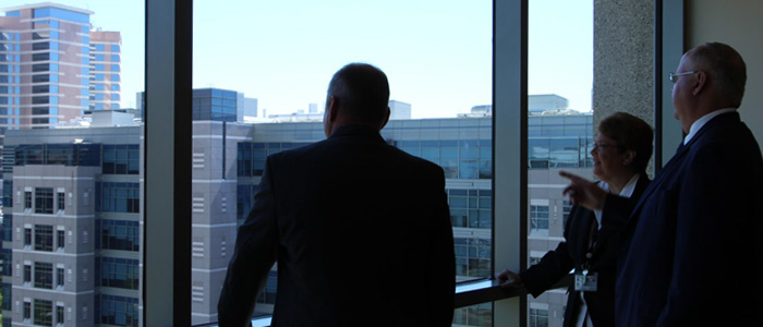 Several UT Police leadership in conversation at window overlooking the Texas Medical Center.